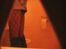 Sexy amateur pissing on toilet wears fishnet and short skirt
