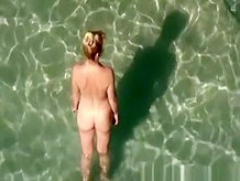 Nudist woman takes off her black bikini