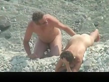Nude couple spied in rocky beach