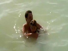 Nudist couple caught fucking in the water