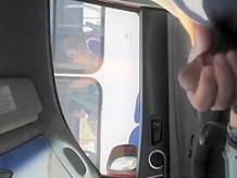 Guy strokes his cock in traffic next to woman in bus