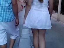 Upskirt of a girl holding hands with a guy