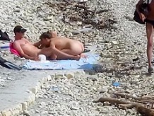 Sensual girl jumps on her boyfriend's fat dick at the nude beach
