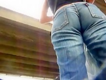 Big round blonde booty in jeans at the bus stop