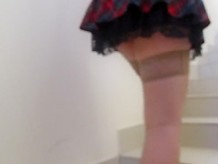 Girl in miniskirt and stockings going upstairs