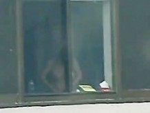 window voyeur - busty girl changing clothes