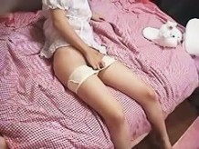Japanese girl plays with her hairy pussy on her pink bed