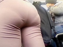 Big culo en leggings marrones que muestran una línea de bragas profundas